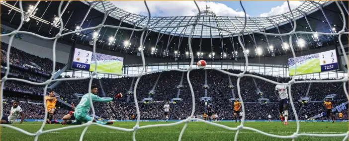  ?? SIMON DAEL ?? Winner time: Wolves striker Jimenez (second from left) leaves Tottenham’s Tanganga sprawling as he fires the ball past Gazzaniga to clinch victory