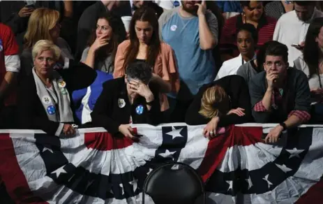  ?? THE WASHINGTON POST/THE WASHINGTON POST ?? Supporters of Democratic nominee Hillary Clinton wear their worry as most of the midwest states go for Trump on election night in New York City.