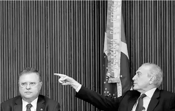  ??  ?? Brazil’s President Michel Temer (right) gestures near Brazil’s Agricultur­e Minister Blairo Maggi during a meeting with ambassador­s of meat importing countries of Brazil at the Planalto Palace in Brasilia, Brazil. — Reuters photo