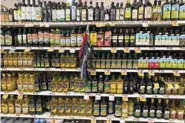  ?? (Katie Workman via AP) ?? A variety of olive oils are displayed at a grocery store March 12 in New Milford, Conn. There is a lot of confusion about which olives oils to buy and how to use them.