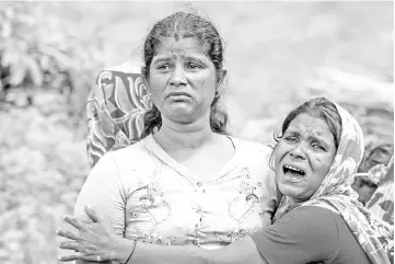  ??  ?? In this file photo show Hindu women cry near the dead bodies of their family members in Ye Baw Kyaw village, Maungdaw in Myanmar’s northern Rakhine state. — AFP photo