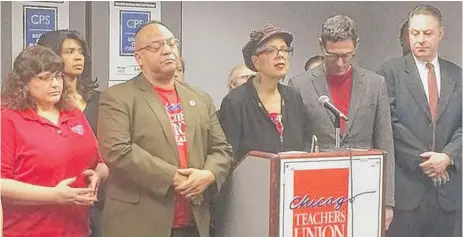  ?? | TINA SFONDELES/ FOR THE SUN- TIMES ?? CTU President Karen Lewis, flanked by union officials, said Friday that a strike is “still on the table.”