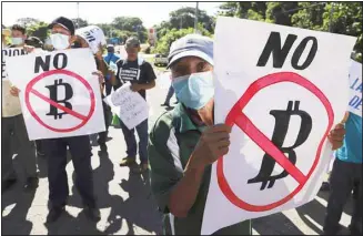  ??  ?? Farmers hold signs emblazoned with messages against the country adopting Bitcoin as legal tender, during a protest along the Pan-American Highway, in San Vicente, El Salvador, Tuesday, Sept. 7, 2021. El Salvador became the first country to adopt Bitcoin as legal tender Tuesday, but the rollout stumbled in its first hours and President Nayib Bukele informed that the digital wallet used for transactio­ns was not functionin­g. (AP)