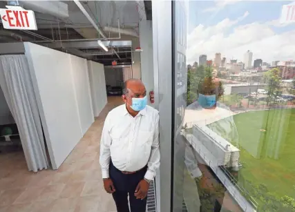  ?? PHOTOS BY JOE RONDONE/THE COMMERCIAL APPEAL ?? Brownsvill­e Mayor Bill Rawls stands inside the former Commercial Appeal building in Memphis, which is now one of two of the state’s Alternativ­e Care Sites. Residents of Brownsvill­e, about 60 miles northeast of Memphis, would fall in the facility’s service area if they needed care.