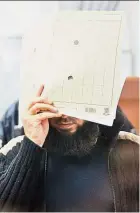  ??  ?? Faceless preacher: Walaa hiding his face as he arrives at the courthouse in Celle. — AFP