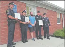  ?? AMANDA HUTCHINSON/THE DAY ?? Officer 1st Class Fred Whitlock, Officer Ben Burbank, motorcycli­st Seth Johnson, Sgt. Alan Muench and Gales Ferry Fire Department Firefighte­r Steven Burns pose for a picture Wednesday after the Ledyard Town Council meeting.