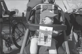  ?? Submitted photos ?? William’s stroller features a picture of his grandmothe­r, Krystyna Groholski during the Bike and Braai fundraiser for KGH on June 7 in Kelowna. Below, Mary Drzewiecki pounds the pavement for her sister.