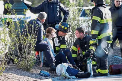  ?? — Reuters ?? Giving a hand: A woman who was injured in the attack in lower Manhattan, New York, being aided by first responders.