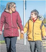 ??  ?? Wendy Moir and son Logan outside Craigiebar­ns Primary in Dundee.