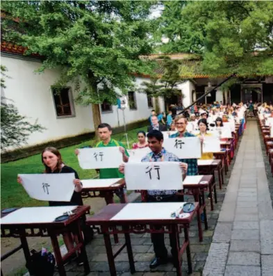  ??  ?? July 6, 2014: Internatio­nal students participat­ing in the 13th Chinese Bridge display their Chinese handwritin­g at Yuelu Academy. CFP