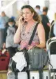  ?? MARTA LAVANDIER/AP ?? A traveler waits to be picked up Saturday at Miami Internatio­nal Airport.