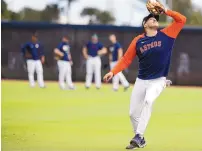  ?? KAREN WARREN/HOUSTON CHRONICLE VIA AP ?? Houston Astros shortstop Carlos Correa catches a pop out during spring training baseball in West Palm Beach, Fla., on Monday.