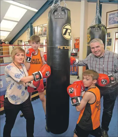  ?? Photograph: Iain Ferguson, Alba.photos. ?? Young boxers Jack Dieguno (left) and Josh Hunter (right) test out the new punch bags bought by Lochaber Phoenix Boxing Club, with assistance from Rosie Flannigan and Kerry MacDonald of Liberty British Aluminium.