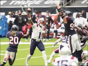  ?? Brett Coomer / Houston Chronicle ?? Texans defensive end J.J. Watt (99) knocks down a pass by Patriots quarterbac­k Cam Newton during the fourth quarter on Sunday at NRG Stadium in Houston.