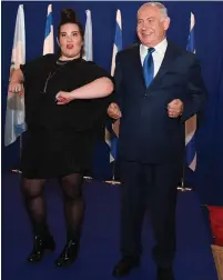  ?? (Haim Zach/GPO) ?? EUROVISION WINNER Netta Barzilai and Prime Minister Benjamin Netanyahu do Netta’s signature chicken dance.