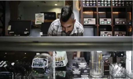  ?? JAE C. HONG/THE ASSOCIATED PRESS ?? Jerred Kiloh, owner of a medical marijuana dispensary in California, is forced to deal strictly in cash — $15,000 (U.S.) can change hands on a typical day.