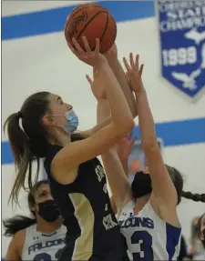  ?? KEN SWART — FOR MEDIANEWS GROUP ?? Stoney Creek’s Milana Skoric shoots for two of her game-high 12points as Rochester’s Alaina Webb (23) defends during the D1district final played on Friday at Rochester High School. The Cougars defeated the Falcons 37-14 to win the title.