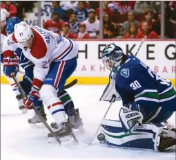  ?? The Canadian Press ?? Montreal Canadiens centre Alex Galchenyuk tries to get a shot past Vancouver Canucks goalie Ryan Miller during first-period NHL action in Vancouver on Tuesday. Montreal won 2-1 in overtime.