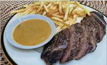  ?? FIGUERAS/LIGAYA.FIGUERAS@AJC.COM LIGAYA ?? The steak frites from Tiny Lou’s are a reliable entree choice.