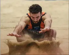  ??  ?? Ben Browne Roche lands in the U23 long jump event.