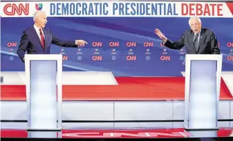  ?? Photos by Evan Vucci / Associated Press ?? Sen. Bernie Sanders, right, sought to draw sharp contrasts with former Vice President Joe Biden during Sunday’s debate. But both agreed an elbow bump was more appropriat­e than a handshake.