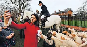  ??  ?? Left, a selfiesnap­per captures a shot of the hounds of the Chiddingfo­ld, Leconfield and Cowdray Hunt yesterday at its Boxing Day meet in Petworth Park, and right, the hunt moves out across the Sussex countrysid­e