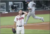  ?? CURTIS COMPTON — ATLANTA JOURNAL-CONSTITUTI­ON VIA AP ?? Braves relief pitcher Grant Dayton, center, reacts after giving up a home run to Dodgers shortstop Corey Seager during the third inning in Game 3of the National League Championsh­ip Series onWednesda­y in Arlington, Texas.