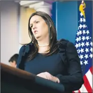  ?? AP/ANDREW HARNIK ?? White House press secretary Sarah Huckabee Sanders arrives for the daily briefing Wednesday. “The president has done nothing wrong. There are no charges against him,” Sanders said, labeling as “ridiculous” accusation­s that President Donald Trump had lied about payments by former lawyer Michael Cohen to two women.