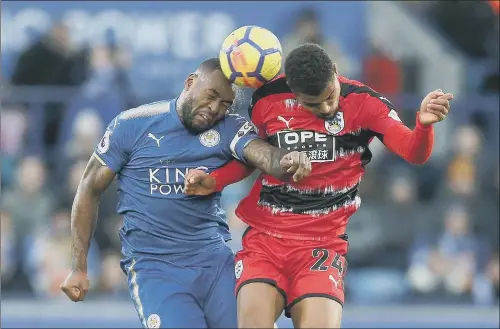  ?? PICTURE: NIGEL FRENCH/PA WIRE ?? MY BALL: Leicester City’s Wes Morgan and Huddersfie­ld Town’s Steve Mounie, right, indulge in an aeriel duel for possession.