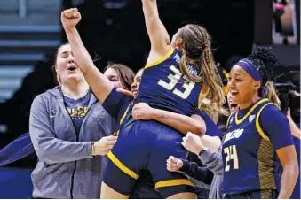  ?? AP PHOTO/WADE PAYNE ?? Toledo guards Yaniah Curry (24), Sammi Mikonowicz (33) and Justina King celebrate after the 12th-seeded Rockets upset fifth-seeded Iowa State in the first round of the NCAA tournament Saturday in Knoxville.