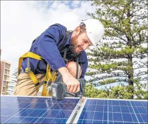  ?? SUBMITTED PHOTO ?? A technician installs solar panels on a building. Nova Scotia is testing its potential for solar energy generation.