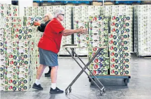  ?? ANDREW FRANCIS WALLACE TORONTO STAR FILE PHOTO ?? Warehouse workers prepare boxes for Santa Claus Fund gift recipients last year.