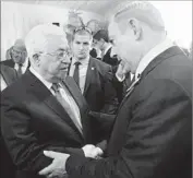  ?? Amos Ben Gershom Israeli Government Press Office ?? MAHMOUD ABBAS of the Palestinai­an Authority, left, shakes hands with Benjamin Netanyahu.