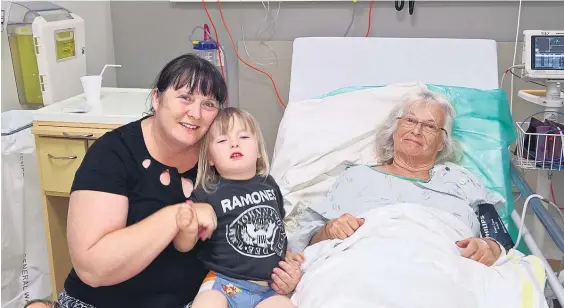  ??  ?? Jan King was knocked unconsciou­s by a kite surfer on Takapuna Beach and missed yesterday’s Adele concert. Her daughter Mandi Buswell, pictured with her 2-yearold son Wilkinson, was still planning on going.