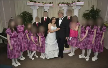  ?? VIA FACEBOOK ?? David Allen Turpin and Louise Anna Turpin are seen with their 13children on a Facebook post. The parents were each sentenced to 25years to life in state prison in 2019for imprisonin­g their children. On Friday, Riverside County released an outside report on its care of the Turpin siblings once they were freed from captivity.