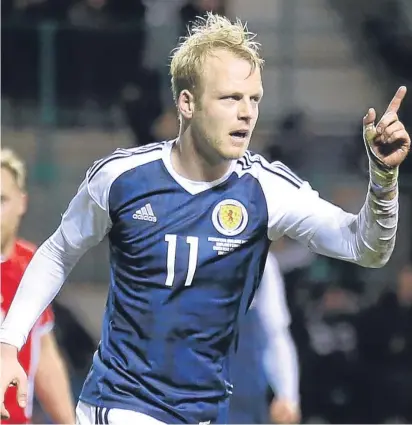  ?? Pictures: SNS/PA. ?? Left: Scotland defender Charlie Mulgrew in an aerial battle with Canadian Simeon Jackson; above: a relieved Steven Naismith celebrates after knocking in Scotland’s equaliser.