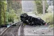  ?? PHOTO BY KEVIN WEXLER — NORTHJERSE­Y.COM VIA AP ?? The remains of a Porsche SUV that plummeted off an overpass, rests on train tracks below, where it burst into flames Sunday afternoon, killing two teenagers and sending a third to a hospital with serious injuries. in Pearl River, NY, Sunday.