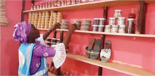  ??  ?? Halima Ibrahim arranging products in her shop