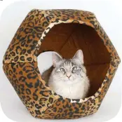  ?? ?? Every cat needs a cozy cave to call his own. The Cat Ball thoughtful­ly created a double-entrance cat bed, keeping in mind how much cats love to peer, swat, and hide! With two entry points for twice the fun, your cat can play out of either side of this bed with any dangling toys you’d like to tempt them with. The cat bed is made in the USA with 100% cotton fabric, and is squeezable and foldable for easy transport. $55, TheCatBall.com