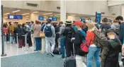  ?? ORLANDO SENTINEL ?? Travelers wait in security check lines at Orlando Internatio­nal Airport.