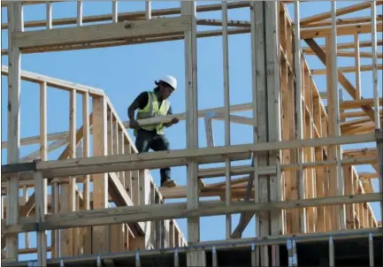  ?? MARK HUMPHREY — THE ASSOCIATED PRESS ?? Workers build an apartment and retail complex in Nashville, Tenn. On Friday, the Commerce Department issued the first estimate of how the U.S. economy performed in the October-December quarter.