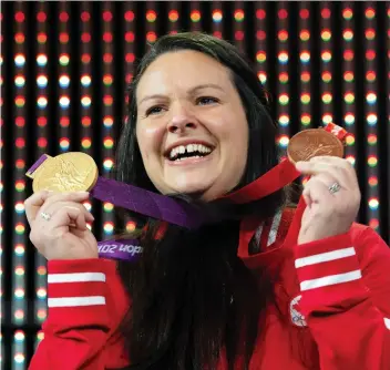  ?? ADRIAN WyLD / THE CANADIAN PRESS ?? Canadian weightlift­er Christine Girard was awarded gold and bronze Olympic medals during a ceremony Monday in Ottawa. Girard was awarded the London 2012 gold and Beijing 2008 bronze medals after the IOC disqualifi­ed athletes from both Olympic Games.