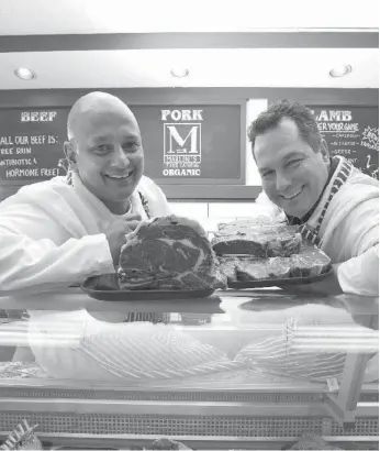  ?? TARA WALTON/TORONTO STAR FILE PHOTO ?? Marlon Pather, left, poses with his head butcher Eric Davis at the now-defunct store The Butchers. Pather issued a flurry of discounted coupons with several websites, then shut his shop and reopened it under a new name.