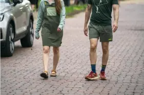  ?? Benjamin B. Braun/Post-Gazette ?? Outdoor fashion from 3 Rivers Outdoor Co. on the streets of Regent Square: A Cotopaxi Tolima Overall Dress, a PA Climbing T-shirt by local artist the Good Newts and Cotopaxi Brinco men's shorts.