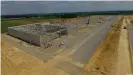  ??  ?? Roughly 250 constructi­on workers are currently building the first of eight huge warehouses at e-Valley