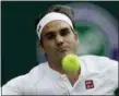  ?? KRISTY WIGGLESWOR­TH — ASSOCIATED PRESS ?? Roger Federer returns the ball to Lukas Lacko during Wednesday’s second-round match in London.
