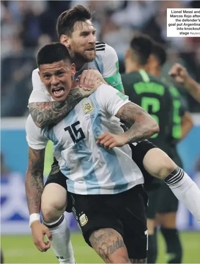  ?? Reuters ?? Lionel Messi and Marcos Rojo after the defender’s goal put Argentina into knockout stage