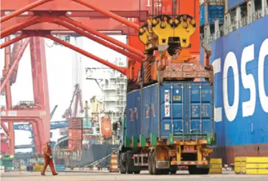  ??  ?? Containers for overseas trade are unloaded from a ship at a port of Lianyungan­g, East China's Jiangsu province, on April 14. Customs data showed that China's exports rebounded in April to rise 3.5 percent over a year earlier following easing coronaviru­s restrictio­ns, while imports fell 14.2 percent.