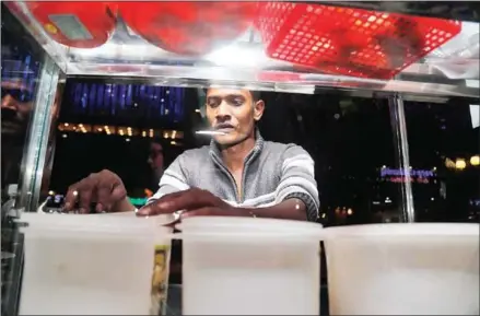  ?? HENG CHIVOAN ?? Mohammed Rashid at his cart on Sothearos Boulevard, where he serves up a taste from home – roti with a variety of toppings – on a plaza along Sothearos Boulevard.