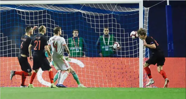  ?? — Reuters ?? Better brace for it: Croatia’s Tin Jedvaj scoring their second goal against Spain in the Nations League match on Thursday.